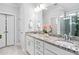 Bright bathroom featuring granite countertops, dual sinks, and a large mirror at 2806 High Plains Dr, Fuquay Varina, NC 27526