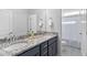 Bathroom featuring a double vanity with granite countertop and a view of the toilet and shower behind at 2806 High Plains Dr, Fuquay Varina, NC 27526