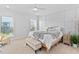Calming bedroom with paneled accent wall, neutral colors, bright windows, and modern furniture at 2806 High Plains Dr, Fuquay Varina, NC 27526