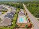 Aerial view of a neighborhood pool showcasing lounge chairs and well-maintained landscaping in a community at 2806 High Plains Dr, Fuquay Varina, NC 27526