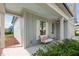 Cozy, covered porch features a comfortable seating area and view of the landscaped front yard at 2806 High Plains Dr, Fuquay Varina, NC 27526