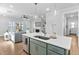 Open concept kitchen with quartz counters, an island with seating, and stainless steel appliances at 2806 High Plains Dr, Fuquay Varina, NC 27526