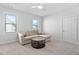 Cozy living room with a comfortable sofa, a round coffee table, and two windows for natural light at 2806 High Plains Dr, Fuquay Varina, NC 27526
