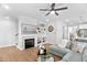 Inviting living room featuring a fireplace, built-in shelving, modern decor, and a comfortable sectional sofa at 2806 High Plains Dr, Fuquay Varina, NC 27526