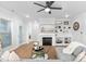 Living room featuring a fireplace, built-in shelving, and a glass door to the exterior of the home at 2806 High Plains Dr, Fuquay Varina, NC 27526
