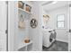 Mudroom and laundry room with built-in bench, hanging hooks, overhead baskets, and stainless steel washer and dryer at 2806 High Plains Dr, Fuquay Varina, NC 27526