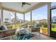Inviting screened porch with comfortable seating, a ceiling fan, and neighborhood views at 2806 High Plains Dr, Fuquay Varina, NC 27526