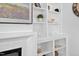 Close up of the built-in shelving near a fireplace with decor and a television above the mantle at 2806 High Plains Dr, Fuquay Varina, NC 27526