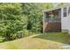 Lawn view of back of house, featuring a screened porch and a fence enclosing the grassy yard at 2914 Farmhouse Dr, Apex, NC 27502