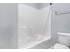 Bathroom showing the tub and shower combination with white tile and gray walls at 2914 Farmhouse Dr, Apex, NC 27502