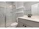 Modern bathroom features a glass enclosed shower, floating shelves, vanity and tiled floors at 2914 Farmhouse Dr, Apex, NC 27502