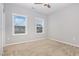 Bright bedroom with two large windows, neutral carpet, and freshly painted light gray walls at 2914 Farmhouse Dr, Apex, NC 27502