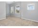 Bedroom featuring three windows providing ample natural light and neutral colored walls and carpet at 2914 Farmhouse Dr, Apex, NC 27502