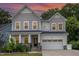 Charming two-story home with a gray shingle and white siding exterior and a two-car garage at 2914 Farmhouse Dr, Apex, NC 27502