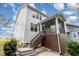 Exterior view of a two-story white home with a screened porch and steps to the backyard at 2914 Farmhouse Dr, Apex, NC 27502
