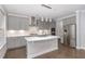 Modern kitchen with gray cabinets, stainless steel appliances, and quartz countertops at 2914 Farmhouse Dr, Apex, NC 27502