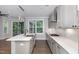 Bright kitchen featuring a center island with stainless steel sink, gas range, and natural light at 2914 Farmhouse Dr, Apex, NC 27502