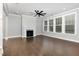 Bright, open-concept living room with fireplace, hardwood floors, and large windows at 2914 Farmhouse Dr, Apex, NC 27502