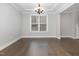 Spacious living room features hardwood floors, recessed lighting, and a modern chandelier at 2914 Farmhouse Dr, Apex, NC 27502