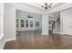 Bright living room featuring hardwood floors, a modern light fixture and an open concept floorplan at 2914 Farmhouse Dr, Apex, NC 27502