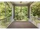Inviting screened porch with wood flooring offers serene views of the surrounding nature at 2914 Farmhouse Dr, Apex, NC 27502