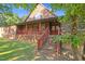 Charming home featuring a brick foundation, wood siding, covered porch, and brick steps at 3129 Tarheel Clubhouse Rd, Raleigh, NC 27604