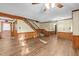 Living room featuring laminate flooring, paneled walls and a wooden staircase at 3129 Tarheel Clubhouse Rd, Raleigh, NC 27604