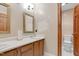Powder room featuring white countertop, wood cabinets and lighting at 3129 Tarheel Clubhouse Road Rd, Raleigh, NC 27604