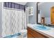 Full bathroom featuring shower/tub combo, storage cabinet and sink at 3129 Tarheel Clubhouse Road Rd, Raleigh, NC 27604