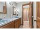 Vintage bathroom featuring double sinks, wood cabinetry and shower at 3129 Tarheel Clubhouse Road Rd, Raleigh, NC 27604