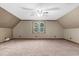 Finished attic bedroom featuring slanted ceilings, ceiling fan and window at 3129 Tarheel Clubhouse Road Rd, Raleigh, NC 27604