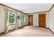 Bedroom with neutral carpet, two windows, and wood trim doors at 3129 Tarheel Clubhouse Road Rd, Raleigh, NC 27604