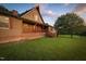 Exterior shot features a two-story home with a brick foundation, wooden deck, and well-manicured lawn at 3129 Tarheel Clubhouse Road Rd, Raleigh, NC 27604