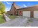 Charming home with a ramp, brick chimney, and a two-car garage, nestled in a serene setting at 3129 Tarheel Clubhouse Road Rd, Raleigh, NC 27604