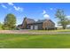 Exterior view showcasing a home with a large two-car garage and grassy lawn at 3129 Tarheel Clubhouse Road Rd, Raleigh, NC 27604