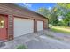 Spacious two-car garage offering ample parking and storage with a red door on a charming home at 3129 Tarheel Clubhouse Road Rd, Raleigh, NC 27604