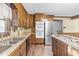 Kitchen boasts wooden cabinets, stainless steel appliances and an island cooktop at 3129 Tarheel Clubhouse Road Rd, Raleigh, NC 27604