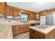 Bright kitchen with wood cabinets, island cooktop, and stainless steel appliances at 3129 Tarheel Clubhouse Road Rd, Raleigh, NC 27604