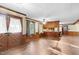 Open-concept kitchen and living room features wood paneling and wooden floors at 3129 Tarheel Clubhouse Road Rd, Raleigh, NC 27604