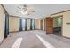 Spacious main bedroom with two windows, ceiling fan and neutral carpet at 3129 Tarheel Clubhouse Road Rd, Raleigh, NC 27604