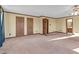 Spacious main bedroom with three doors, windows and neutral carpet at 3129 Tarheel Clubhouse Road Rd, Raleigh, NC 27604