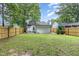 Backyard featuring a wooden fence and small patio at 3649 Guess Rd, Durham, NC 27705