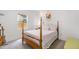 Cozy bedroom with four poster bed, natural light, and simple decor at 3649 Guess Rd, Durham, NC 27705