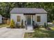 Charming home with a well-maintained lawn, mature trees, and newly stained front door at 3649 Guess Rd, Durham, NC 27705