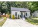 Beautifully landscaped front yard with an inviting front porch and a well maintained white home at 3649 Guess Rd, Durham, NC 27705