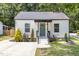 Charming home featuring a well maintained lawn, a cozy porch, and a modern white exterior at 3649 Guess Rd, Durham, NC 27705