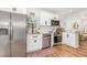 Bright kitchen with white cabinets, stainless steel appliances, and a view from the window at 3649 Guess Rd, Durham, NC 27705