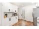 Updated kitchen boasts white cabinets, stainless appliances, and access door at 3649 Guess Rd, Durham, NC 27705