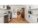 Open kitchen showcases modern stainless steel appliances and hardwood floors at 3649 Guess Rd, Durham, NC 27705