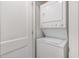 Compact laundry area with stacked washer and dryer units and neutral decor at 3649 Guess Rd, Durham, NC 27705